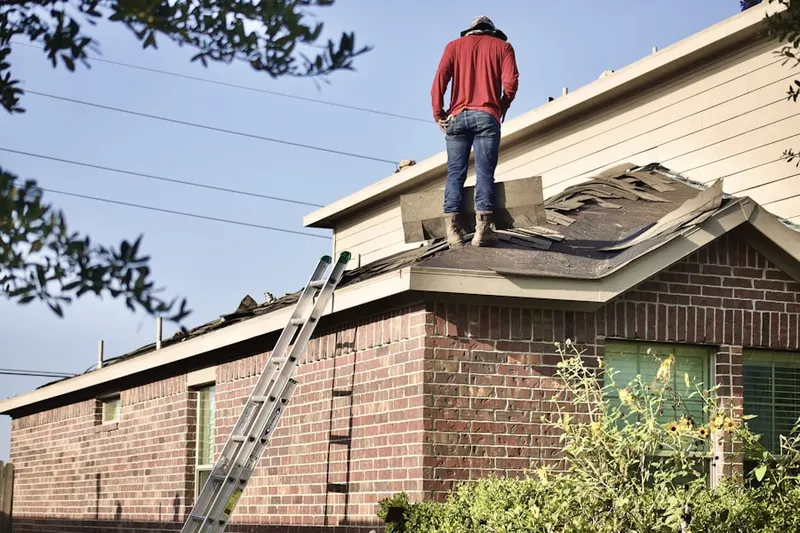 Professional roofer working on a residential roof in Waldenwood